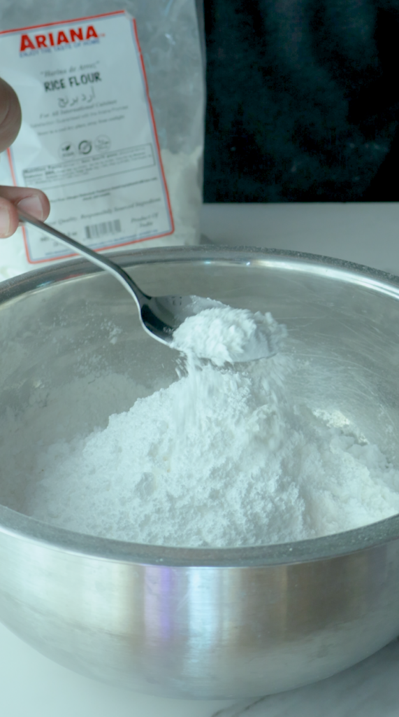 Add rice flour, powdered sugar, baking powder, baking soda and ground cardamom and mix together. 